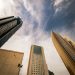 A stunning view of Kuwait City's modern architecture with prominent skyscrapers set against a dramatic sky.
