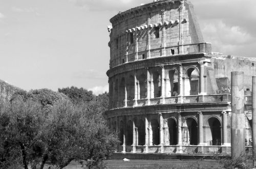 Black and white photo of the Colosseum in Rome, capturing its historic architecture.
