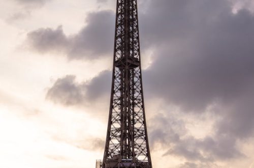 Stunning view of the Eiffel Tower silhouetted against a vibrant sunset sky in Paris, France.
