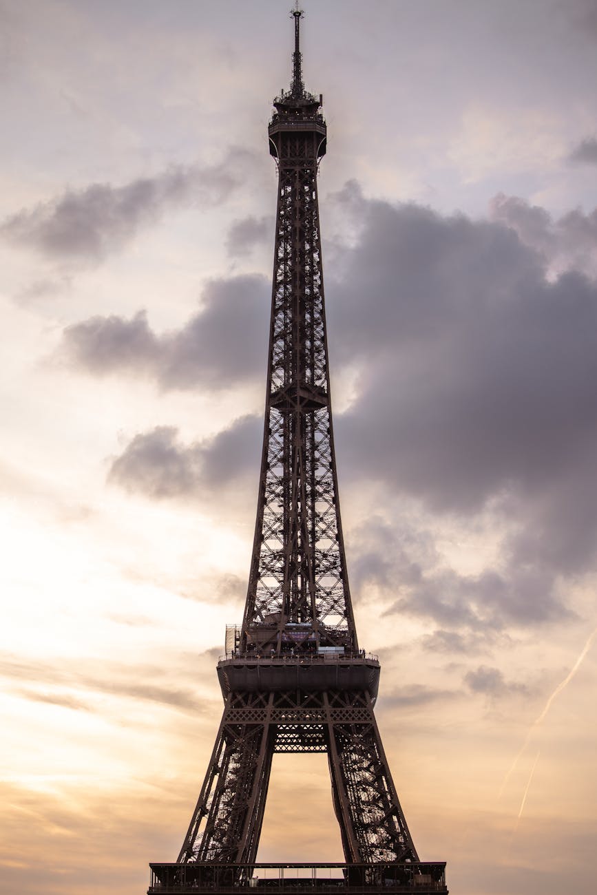 Stunning view of the Eiffel Tower silhouetted against a vibrant sunset sky in Paris, France.