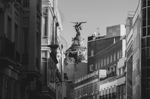 A dramatic black and white image of iconic architecture on Madrid's skyline showcasing urban European charm.