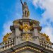Ornate architectural detail with golden statue against a blue sky in Brussels, Belgium.