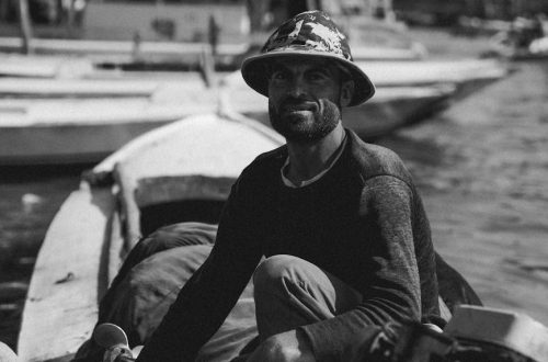 Black and white portrait of a local fisherman on a boat in Cairo, Egypt. Capturing daily life on the Nile.
