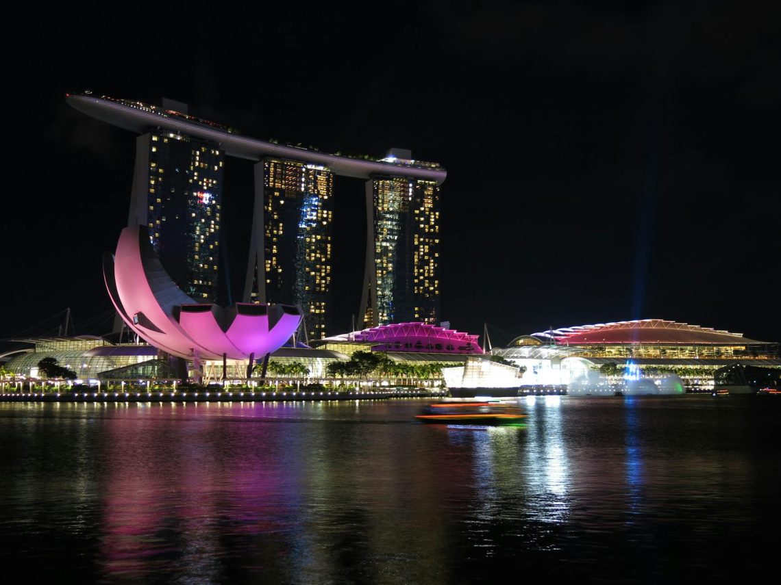 Stunning night view of Marina Bay Sands, Singapore, reflecting on water.