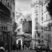 Black and white photo of a Montmartre street with a windmill, Paris, France.