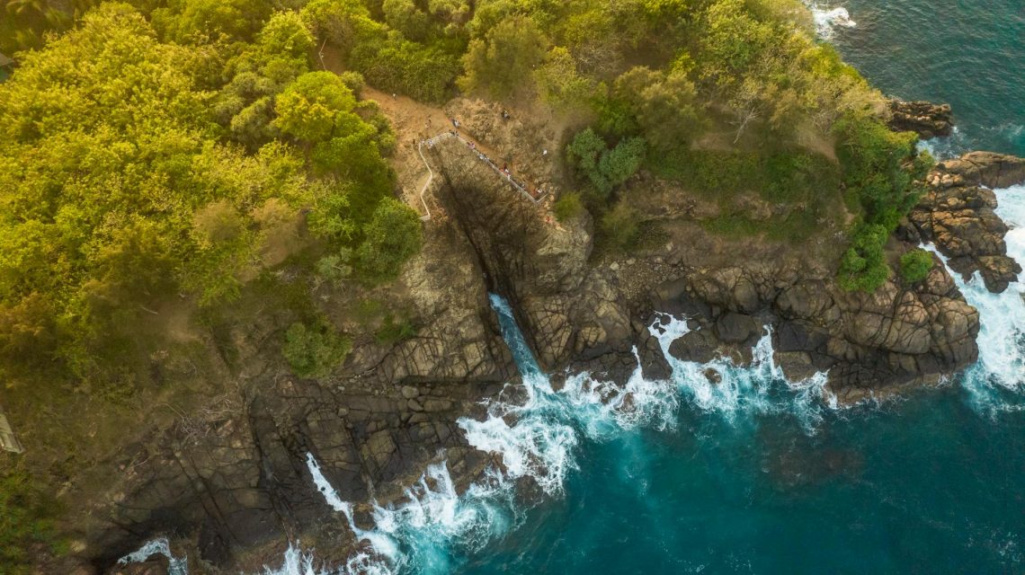 Breathtaking aerial view of Thangalla's rocky coastline and lush greenery.