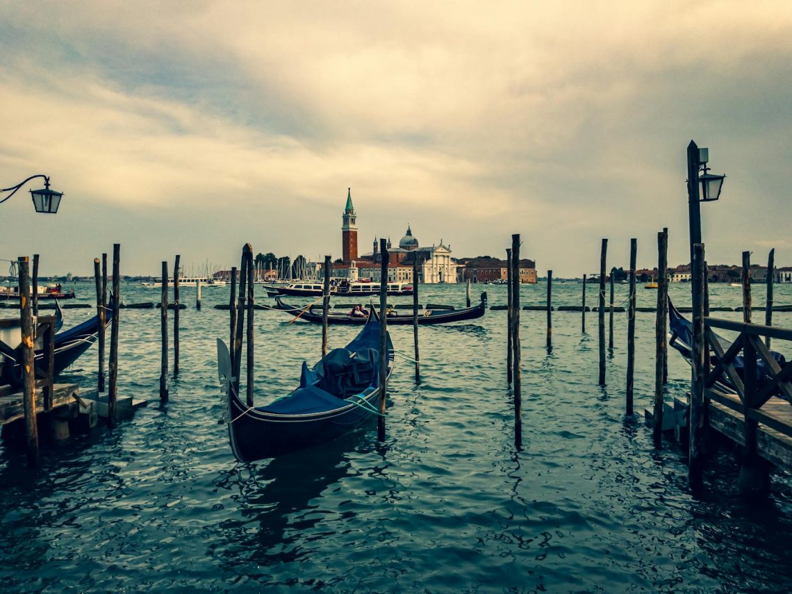 Beautiful view of gondolas on Venice's canals with San Giorgio Maggiore in the background.