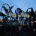 People gather at Pacific Park entrance on Santa Monica Pier at dusk, California.