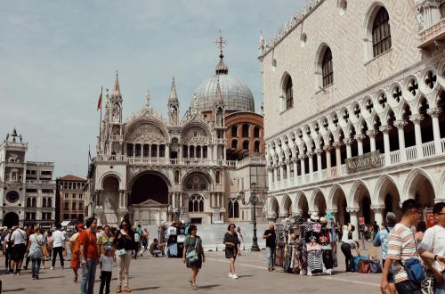 Visitors explore the iconic Piazza San Marco with St. Mark's Basilica in Venice, Italy.