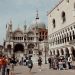 Visitors explore the iconic Piazza San Marco with St. Mark's Basilica in Venice, Italy.