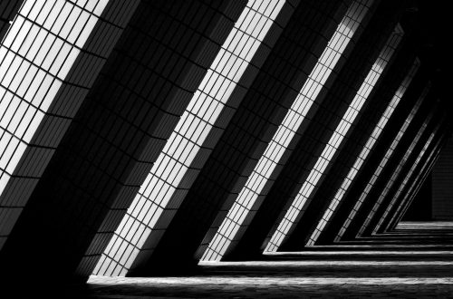 Dynamic black and white photo of modern architectural columns in Hong Kong.