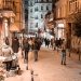 Evening in Istanbul with people strolling through a lively street lit by warm lights.